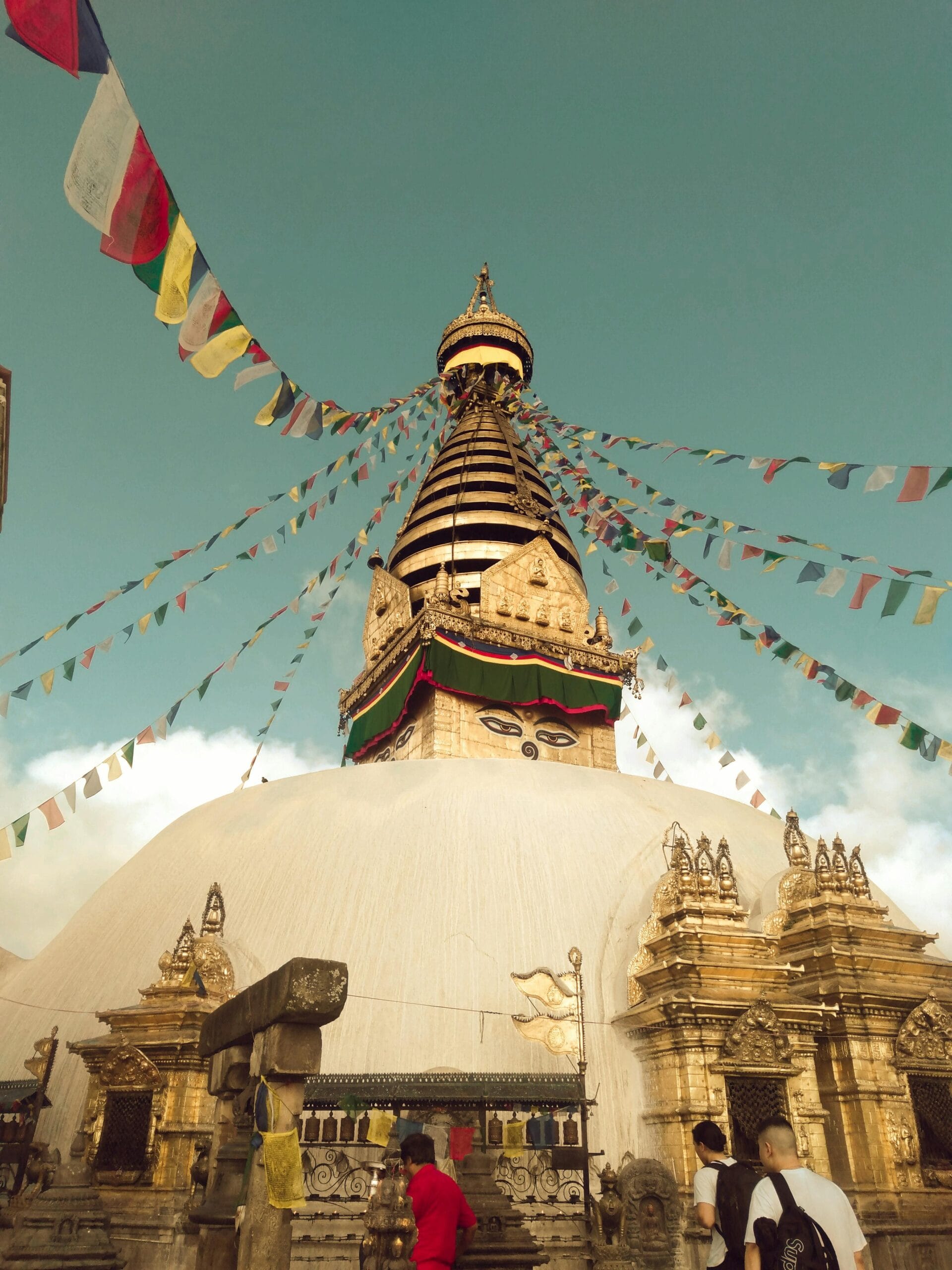 Majestic view of Swayambhunath Stupa with prayer flags in Kathmandu, Nepal.