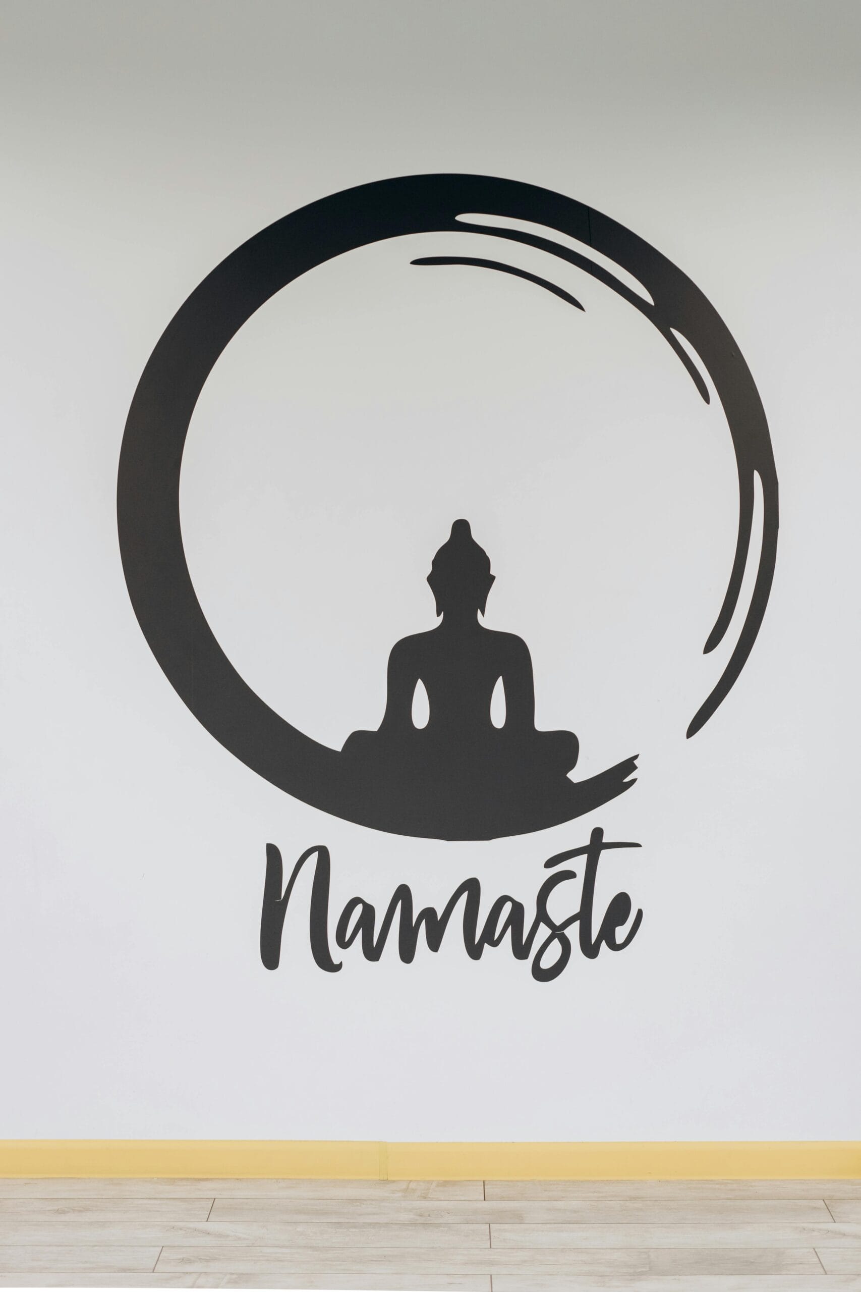 Minimalist wall art featuring a meditation silhouette within a circle and 'Namaste' text.